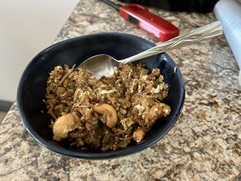 Photo of a left over stir-fried rice with cashews and egg